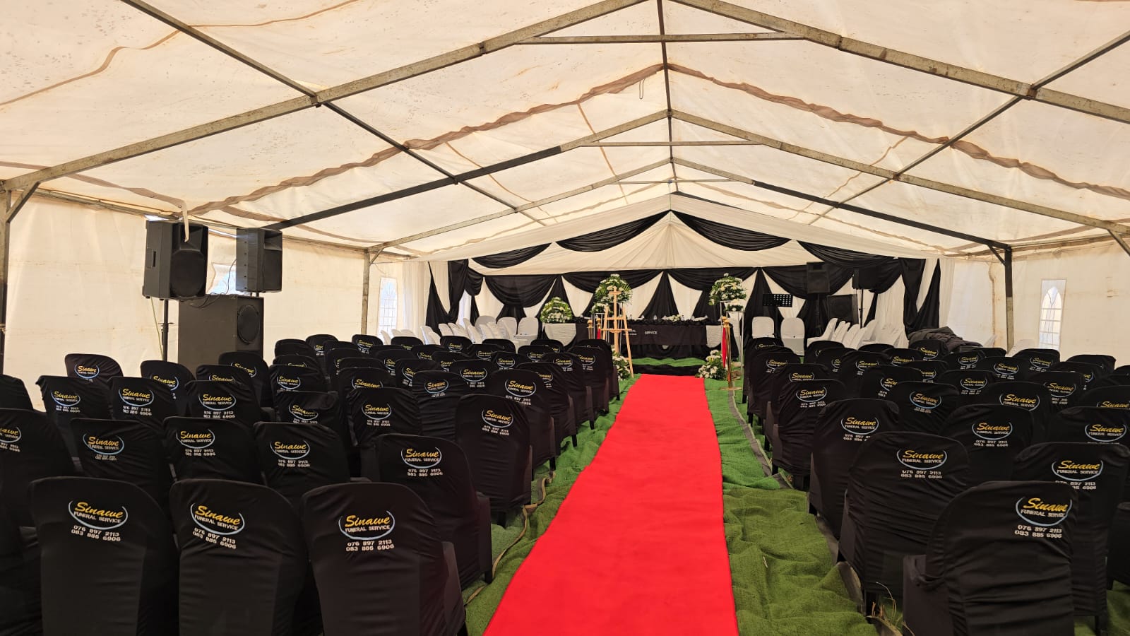 Elegant black and white draped tent with branded chairs