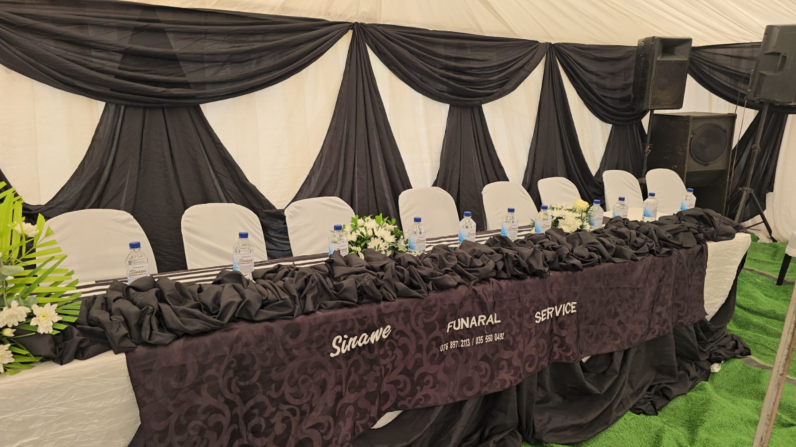 Branded Sinawee Funeral Service main table with white chairs