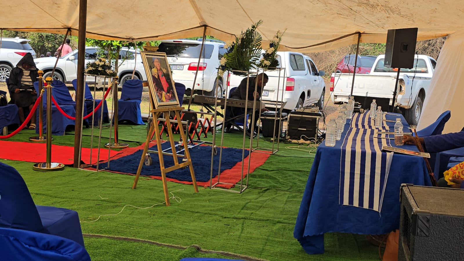 Memorial portrait and sound system setup in the funeral tent