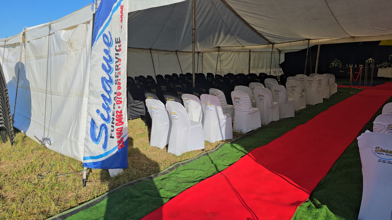 Sinawee branded banner at the funeral tent entrance