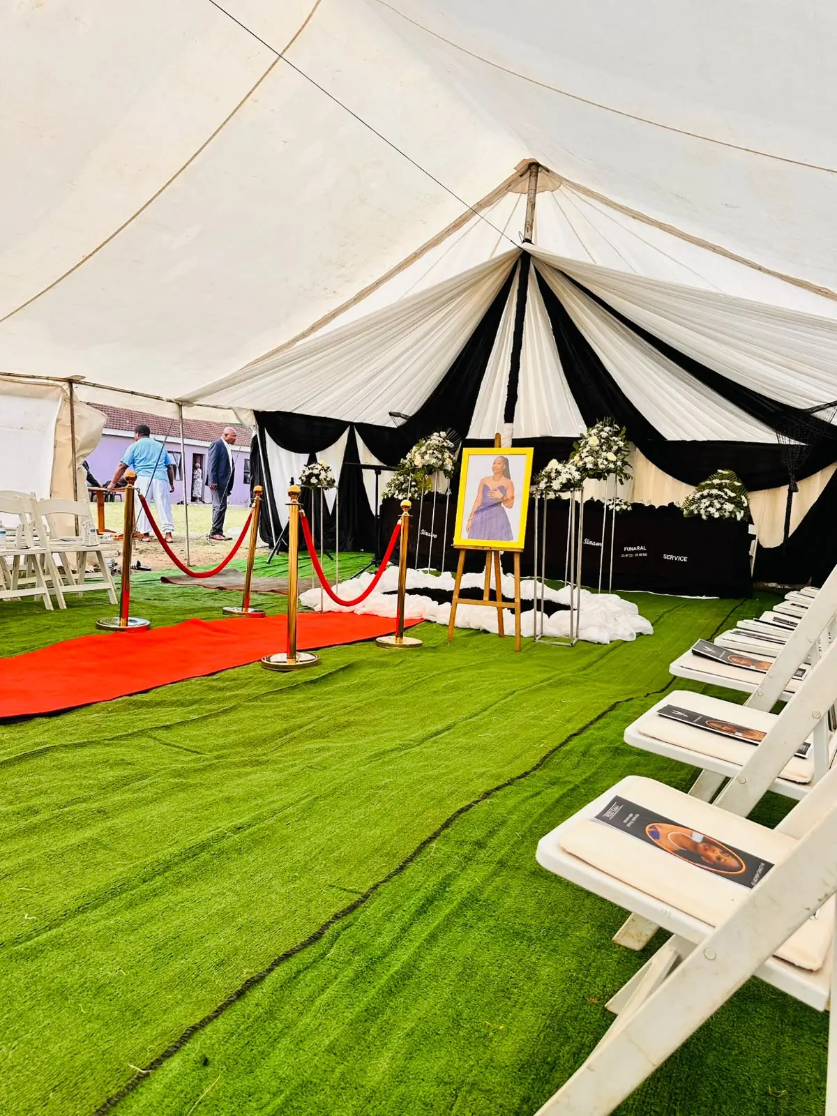 Memorial portrait setup inside a draped Sinawee tent